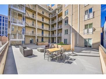Spacious outdoor courtyard with contemporary furniture and views of the building's architecture at 290 W 12Th Ave # 205, Denver, CO 80204