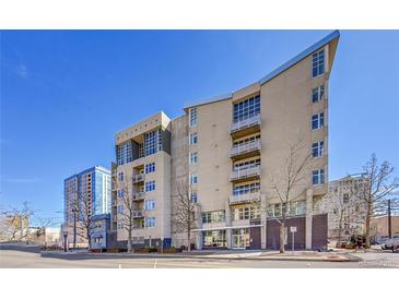 Modern condo building showcasing architectural details and multiple floors with balconies under clear blue skies at 290 W 12Th Ave # 205, Denver, CO 80204