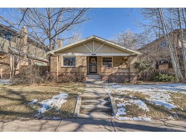 Brick home with front porch, steps, and landscaping at 826 S York St, Denver, CO 80209