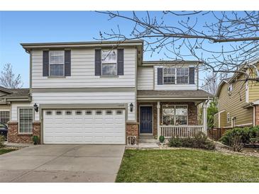 Charming two-story home featuring a well-manicured lawn and attached two car garage at 14245 Corrine Ct, Broomfield, CO 80023