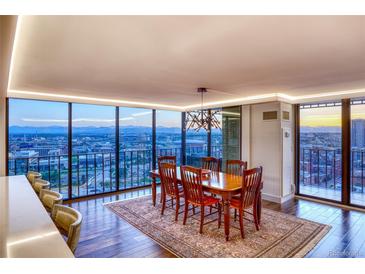 Bright dining area featuring floor-to-ceiling windows with stunning city views and contemporary lighting at 1551 Larimer St # 1901, Denver, CO 80202