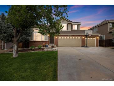 Charming two-story home boasting a well-manicured lawn, brick accents, and a spacious three-car garage at 2753 E 139Th Dr, Thornton, CO 80602