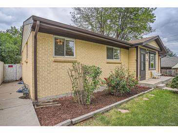 Charming brick home with a well-manicured garden and a cozy, inviting entrance, perfect for curb appeal at 7618 Umatilla St, Denver, CO 80221