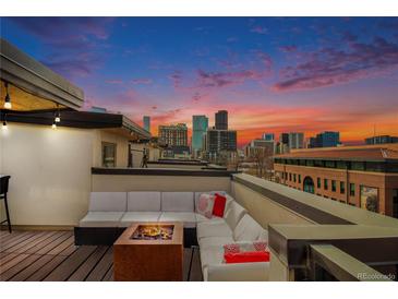 Spacious rooftop deck with city views and fire pit at 2438 Welton St, Denver, CO 80205