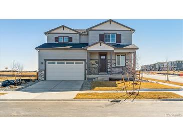 Charming two-story home with a two car garage and covered porch at 25022 E 34Th Pl, Aurora, CO 80019