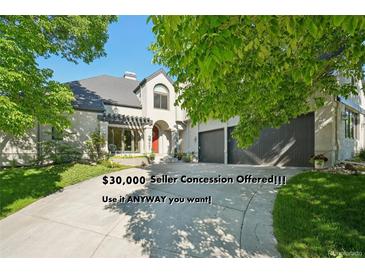 Inviting home featuring a manicured lawn, mature trees, and an attached two car garage at 7081 Salvia St, Arvada, CO 80007