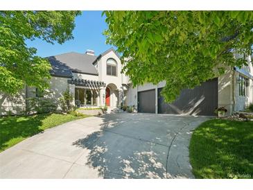 Beautiful two-story home with a well-maintained front yard and a spacious driveway leading to the garage at 7081 Salvia St, Arvada, CO 80007