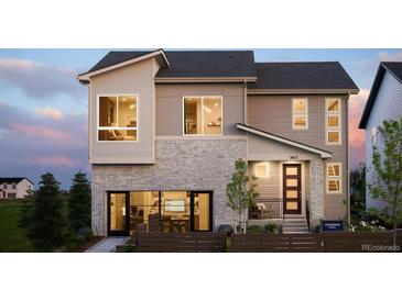 Inviting home showcasing a modern design, multiple windows, and well-maintained landscaping at 5726 Margarita Pt, Parker, CO 80134