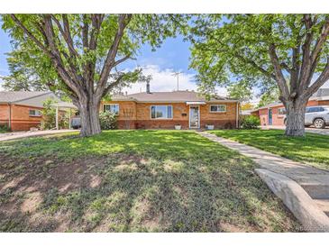 Charming brick home with a well-manicured lawn and mature trees offering great curb appeal at 9221 High St, Thornton, CO 80229