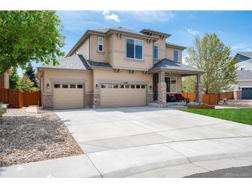 Lovely two-story home featuring a three car garage and covered front porch at 11460 W Tanforan Cir, Littleton, CO 80127