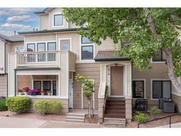 Charming townhome featuring a front patio with beautiful flower planters and a welcoming entrance at 8707 E Florida Ave # 614, Denver, CO 80247