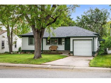 Charming single-story home with well-maintained lawn, attached garage, and mature shade tree at 3231 S Elati St, Englewood, CO 80110