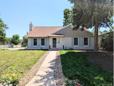 Charming home featuring a well-maintained lawn and inviting walkway at 1054 Magnolia St, Denver, CO 80220