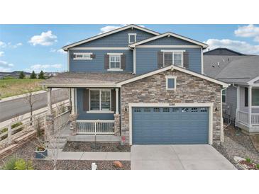 Beautiful two-story home boasts a stone-accented facade and a charming covered front porch at 2188 Abigail Ln, Castle Rock, CO 80104
