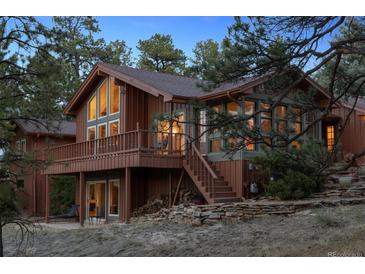 Charming home featuring a balcony, multiple windows and a stone accented facade at 12493 Forest Canyon Dr, Parker, CO 80138