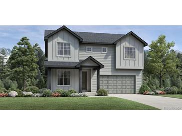 Charming two-story home with modern farmhouse elevation and a two car garage on a green lawn at 6345 Las Conchas Pt, Parker, CO 80134