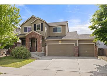 Charming two-story home with a three car garage, brick accents, and covered entry at 41 Jordan Ln, Erie, CO 80516