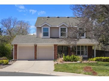Charming two-story home featuring a two-car garage, landscaped yard, and traditional architectural details at 10200 Julian St, Westminster, CO 80031