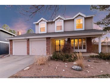 Charming two-story home with a two-car garage and inviting front porch, blending traditional design with modern comfort at 10200 Julian St, Westminster, CO 80031