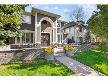 Exterior of a two-story house with landscaping and a walkway at 290 Glencoe St, Denver, CO 80220