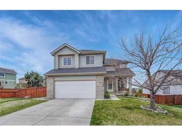 Charming two-story home with a well-maintained lawn and a two car garage on a sunny day at 600 Balsa Dr, Castle Rock, CO 80104