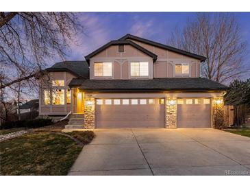 Charming two-story home features a three-car garage, stone accents and neutral stucco at 7636 S Allison Ct, Littleton, CO 80128