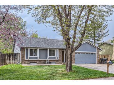 Charming single-Gathering home with a well-manicured lawn and attached two-car garage at 10723 Cherry Ct, Thornton, CO 80233