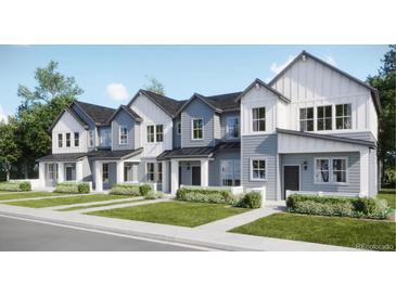 Charming new construction townhomes with Hardie board siding, black windows, and professionally landscaped yards at 6579 Parterre N Pkwy # 2, Thornton, CO 80602