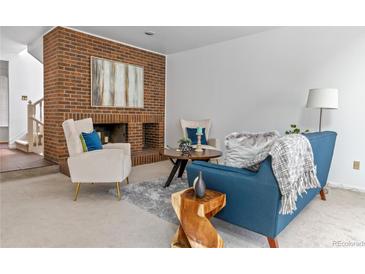 Comfortable living room with a brick fireplace, modern furniture, and neutral décor at 999 N Emerson St # 10, Denver, CO 80218