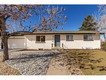 Charming single-story brick home with a well-manicured lawn and inviting front entrance, plus attached garage at 6699 S Pennsylvania St, Centennial, CO 80121