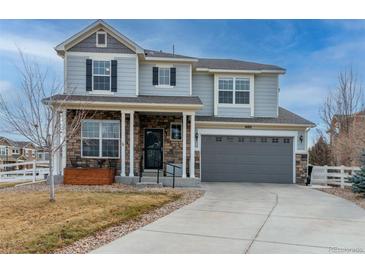 Two-story house with gray siding, stone accents, and a two-car garage at 1682 Dorothy Cir, Longmont, CO 80503