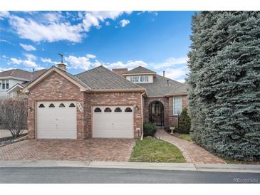 Brick ranch home with two-car garage and landscaped yard at 4272 E Orchard Pl, Centennial, CO 80121