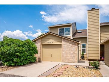 Inviting home exterior showing a charming two-story design, garage, and well-maintained landscaping at 10309 W Fair Ave # E, Littleton, CO 80127