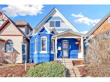 Charming blue home with a covered front porch and beautiful architectural details at 3429 W 34Th Ave, Denver, CO 80211