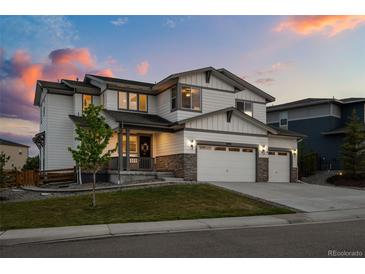 Beautiful two-story home featuring a spacious three-car garage and welcoming covered front porch at 6696 Kenzie Cir, Castle Pines, CO 80108