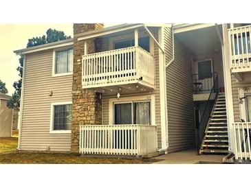 Inviting condo featuring stone accents, two balconies, and well-maintained siding at 14102 E Colorado Dr # 102, Aurora, CO 80012