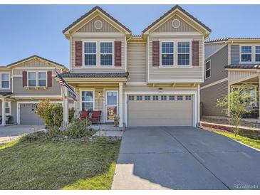 Charming two-story home with tan siding, red shutters, and a well-maintained front yard at 2508 Coach House Loop, Castle Rock, CO 80109