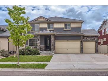 Attractive two story home featuring manicured front yard and three car attached garage at 133 Poppy View Ln, Erie, CO 80516