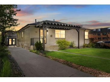 Charming home with a modern pergola and a well-manicured lawn creating great curb appeal at 785 Dexter St, Denver, CO 80220