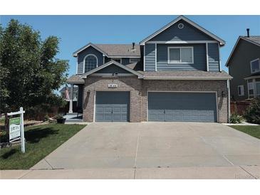 Charming two-story home with brick accents and a spacious three-car garage at 10144 Madison St, Thornton, CO 80229