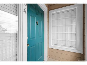 Stylish teal-colored front door with a decorative knocker and prominent unit number at 8475 Pebble Creek Way # 204, Highlands Ranch, CO 80126
