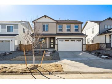 Charming two-story home with a well-manicured lawn and a spacious two-car garage at 1080 Joseph Pl, Erie, CO 80026