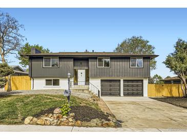 Charming split-level home with a well-manicured lawn, two-car garage, and neutral tones at 6876 Quay Ct, Arvada, CO 80003