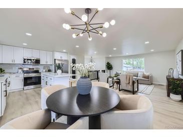 Open-concept layout featuring a modern kitchen, dining area, and comfortable living room at 6876 Quay Ct, Arvada, CO 80003