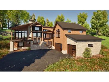 Stunning multi-level home with modern design, complemented by wood and stone accents, and a spacious driveway at 2035 Highlands Dr, Breckenridge, CO 80424