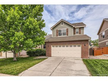 Two story home with brick veneer and two car garage on a sunny day at 2856 Penstemon Way, Castle Rock, CO 80109