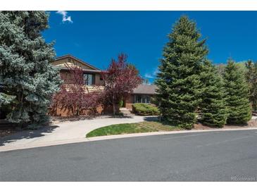 Charming two-story home with landscaped yard and inviting curb appeal, surrounded by mature trees and a well-maintained lawn at 5361 Nassau Cir, Cherry Hills Village, CO 80113