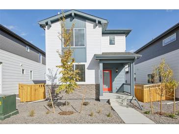 Two-story house with gray and white siding, a red door, and a landscaped front yard at 21021 E 63Rd Dr, Aurora, CO 80019