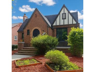 Charming brick Tudor-style home with a well-manicured front yard and unique architectural details at 1470 Utica St, Denver, CO 80204