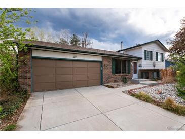 Charming brick home featuring an attached garage and well-kept front yard and inviting curb appeal at 4917 S Xenophon Way, Morrison, CO 80465